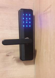 a black remote control sitting on a wooden door at good-goisern hotel in Bad Goisern