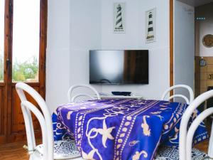 a dining room with a table and chairs and a tv at Villa Lina in Castiglioncello