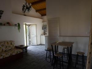 ein Wohnzimmer mit einem Tisch und einem Sofa in der Unterkunft Il palmento di Beppe in Santa Tecla