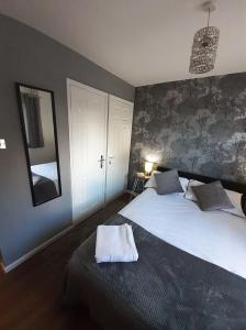 a bedroom with a large bed and a mirror at Hardwick Haven, Sedgefield - Near Hardwick Hall in Stockton-on-Tees