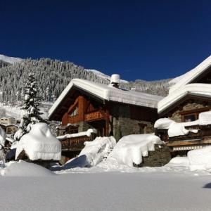 a house covered in snow in front at Chalet Camillou in Champagny-en-Vanoise