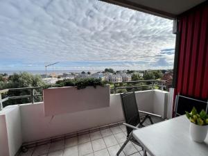 a balcony with a table and a view of the city at Berolina 519 - Ostsee Weitblick in Dahme