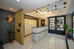 a lobby of a hotel with a counter and plants at Hotel California in Istanbul