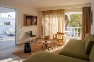 a living room with a couch and a table at Barcarola Club in Puerto del Carmen