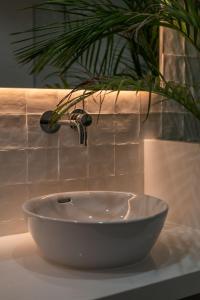 a bathroom sink with a plant and a faucet at Barcarola Club in Puerto del Carmen