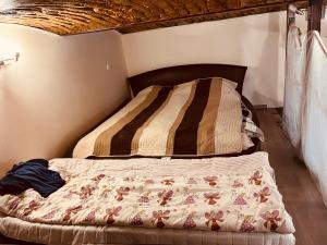 a bed in a room with a bedspread on it at Veres Pálné in Budapest