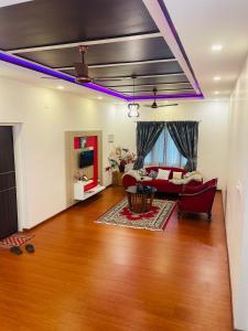 a living room with purple lights on the ceiling at Castle Villa in Ernakulam