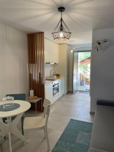 a kitchen and living room with a table and a dining room at Barbi Blue Apartments in Herceg-Novi +15 photos