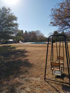 a swing in the middle of a field at El Campo Departamentos in Merlo