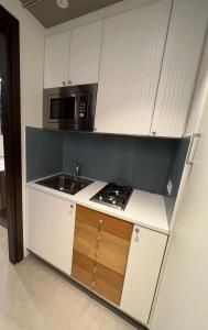 a kitchen with a sink and a microwave at Villa Russo Apartment in Trecastagni