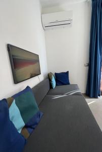 a room with a couch and a flat screen tv at Villa Russo Apartment in Trecastagni