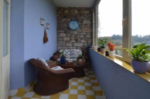 a hallway with chairs and a clock on a wall at Posada Casa de Valle in Colindres