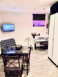 a living room with a table and a desk at Residence Toraldo in Rome