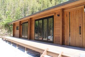 a wooden cabin with windows and a deck at NEXX IKI - Vacation STAY 16966v in Iki