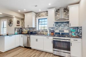 a kitchen with white cabinets and a stove at Banks Cottage ---30708 Whites Neck Rd in Dagsboro