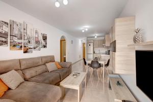 a living room with a couch and a table at La Perla D14 en el Médano in El Médano