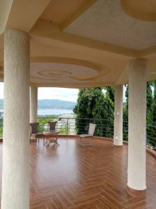 a large room with a wooden floor and a balcony at COAST VIEW RESORT in Kigoma