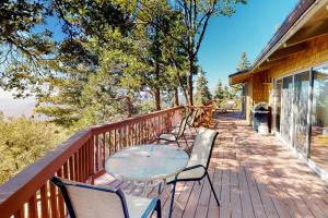 a patio with chairs and a table on a deck at Deer Path Cabin in Idyllwild