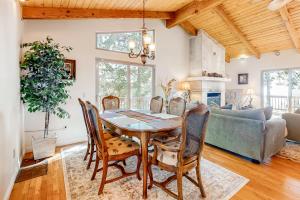 a dining room with a table and chairs and a couch at Deer Path Cabin in Idyllwild