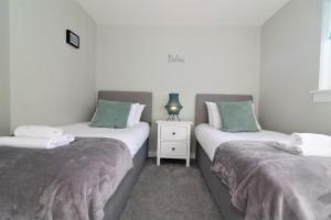 En eller flere senge i et værelse på Signature - Sydney House