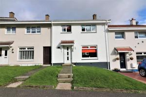 a house with a green lawn in front of it at Signature - Sydney House in East Kilbride