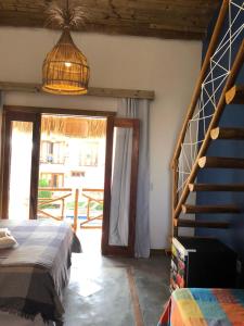 1 dormitorio con 1 cama y escalera de caracol en Pousada Rosa dos Ventos Lagoinha, en Lagoinha