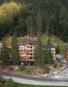 an aerial view of a building with trees and a road at Fevri apartment in Madonna di Campiglio