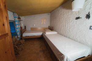 a small room with two beds in it at Fevri apartment in Madonna di Campiglio