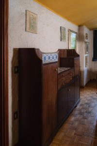 a kitchen with wooden cabinets in a room at Fevri apartment in Madonna di Campiglio