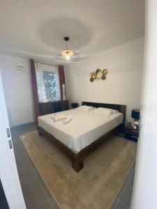 a bedroom with a large bed with white sheets at Rare ***Centre ville * Parking in Montpellier