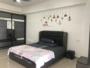 a bedroom with a bed and some purses on the wall at Venus Hollywood Homestay Sitiawan in Seri Manjung +23 photos