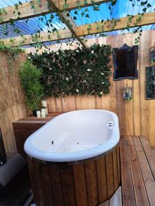 a bath tub sitting on top of a wooden wall at Little Oakhurst in Clitheroe