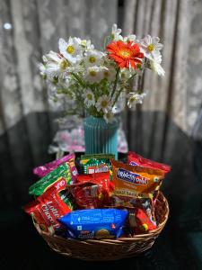 a basket filled with candy and a vase of flowers at The Little Room (A doorway to relaxation) in Gangtok