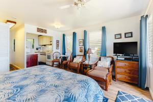 a bedroom with a bed and a kitchen at Kapa'a Sands 14 in Kapaa