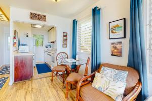 a kitchen and living room with a table and chairs at Kapa'a Sands 14 in Kapaa