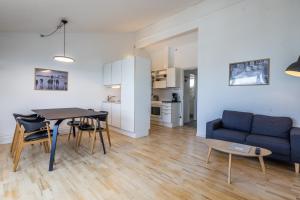 a living room with a blue couch and a table at Hotel Icefiord in Ilulissat