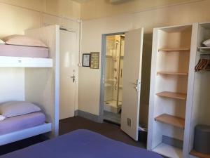 a room with two bunk beds and a walk in shower at AUBERGE RIVA BELLA in Le Touquet-Paris-Plage