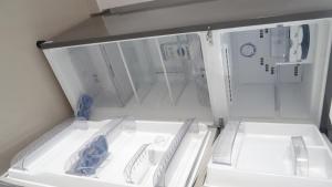un frigorifero aperto con due piatti bianchi di Mirissa Cocoon a Mirissa