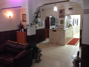a waiting room with a leather couch and a counter at Ekol Hotel in Istanbul
