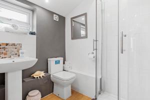 a bathroom with a toilet and a sink and a shower at Cottage in Worcestershire in Evesham