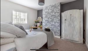 a bedroom with a white bed and a window at Cottage in Worcestershire in Evesham