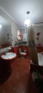 a bathroom with a sink and a tub and a toilet at الاسكندريه - سموحه in Alexandria