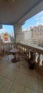 a balcony with a table and chairs and buildings at الاسكندريه - سموحه in Alexandria