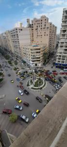 a parking lot with cars in a city with tall buildings at الاسكندريه - سموحه in Alexandria