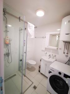a bathroom with a shower and a toilet and a sink at Navissos HEAVEN Premium in Niš