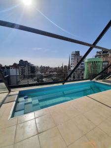 a swimming pool on the roof of a building at LOCADOR Nueva Cordoba 3C in Cordoba