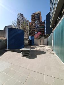 a bench sitting on a sidewalk next to a building at LOCADOR Nueva Cordoba 3C in Cordoba