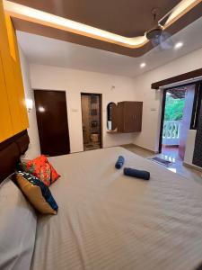 a bedroom with a large bed with two pillows on it at TGI Guest Houses in Calangute