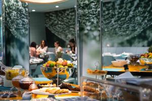 a buffet line with a plate of food in a restaurant at WC by The Beautique Hotels in Lisbon