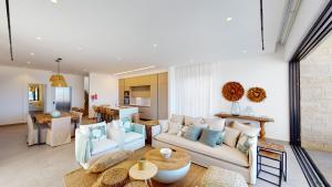 a living room with a couch and a table at Periyiali Konnos Villas Beach Resort in Protaras